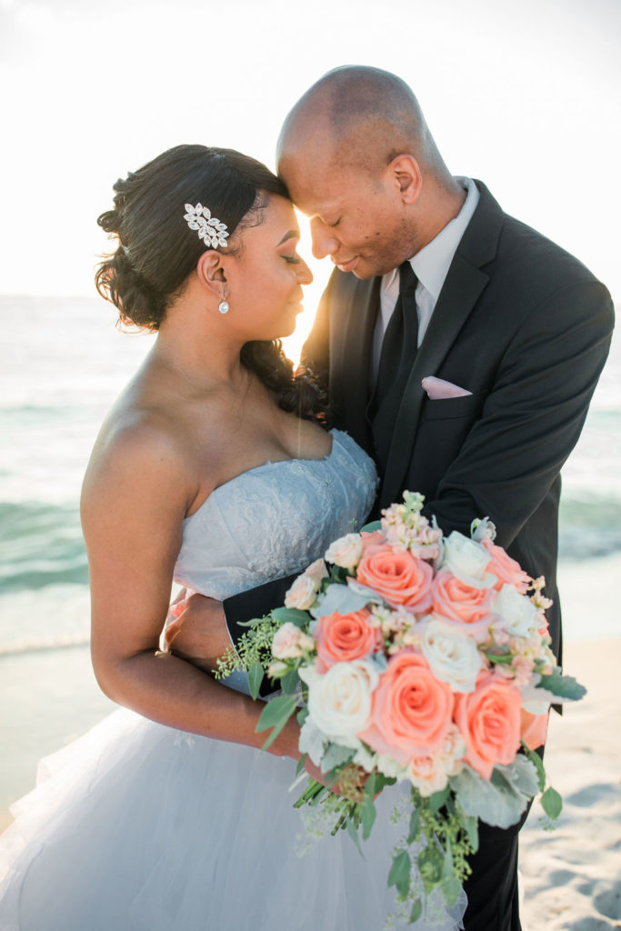 Destin Beach wedding portraits at sunset of an African-American couple that got married at the Emerald Grande Resort in Destin, Florida