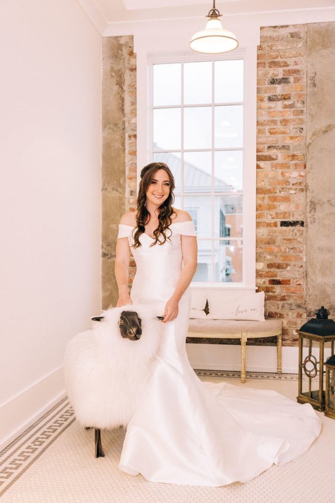 5-Eleven Palafox Bridal Suite - Bride posing with the fluffy sheep