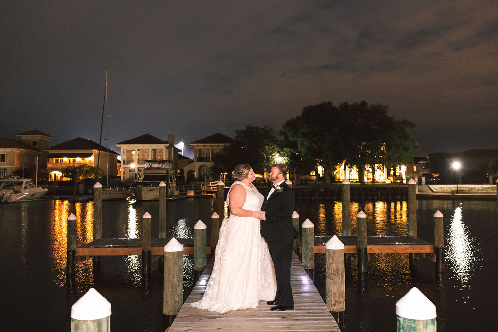 Palafox Wharf Waterfront Wedding event venue bride and groom photos on the dock behind the wedding venue