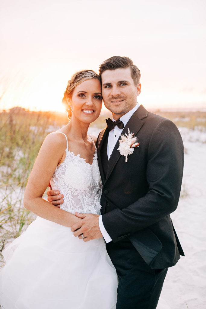 Bride and groom having their faces really close for their Sunset bridal portraits in Pensacola Beach.
