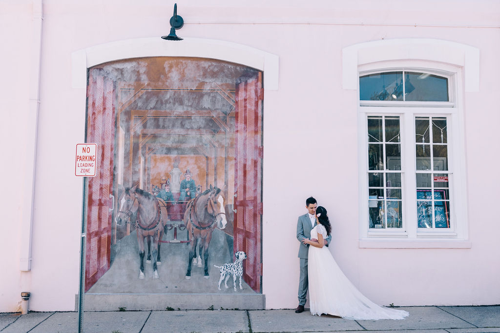 Donwtown Pensacola Pink wall with mural wedding portrait